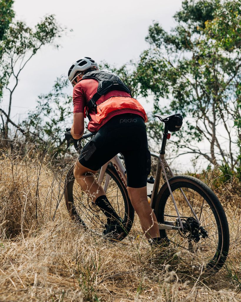 Matt Bird pushing his bike uphill.